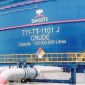 A large blue crude oil storage tank at the Dangote Petroleum Refinery in Lekki, Lagos, marked "711-TTT-1101 J CRUDE" with a storage capacity of 120 million litres, highlighting the refinery's large-scale crude oil storage infrastructure.
