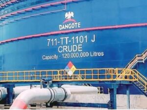 A large blue crude oil storage tank at the Dangote Petroleum Refinery in Lekki, Lagos, marked "711-TTT-1101 J CRUDE" with a storage capacity of 120 million litres, highlighting the refinery's large-scale crude oil storage infrastructure.