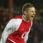 Former Arsenal midfielder David Bentley celebrating during a match in an Arsenal shirt.