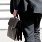 Businessman carrying a briefcase while walking, representing the business and technology market surrounding Nintendo’s expansion into Indonesia.