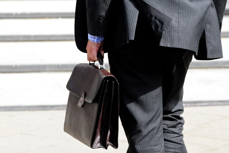 Businessman carrying a briefcase while walking, representing the business and technology market surrounding Nintendo’s expansion into Indonesia.