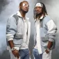 Nigerian music duo P-Square, Peter and Paul Okoye, posing together in matching outfits and sunglasses.