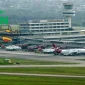 Airline Operators of Nigeria logo over Lagos airport terminal with Virgin Nigeria aircraft on the tarmac.