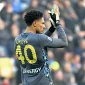 Maduka Okoye in Udinese goalkeeper jersey waving to fans inside a football stadium.