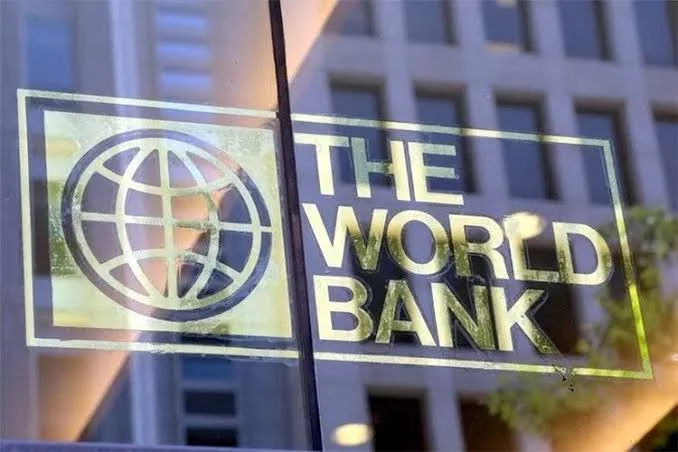 World Bank logo displayed on a glass window with reflections of a modern office building in the background.
